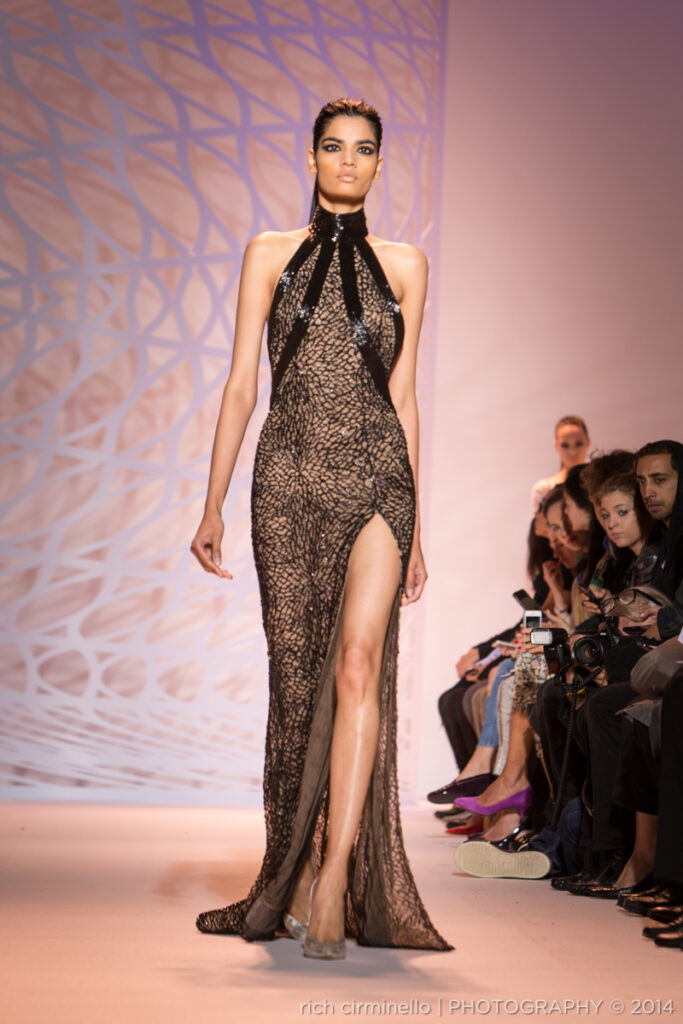 Model in a black Zuhair Murad gown with a thigh-high slit at Paris Haute Couture Fashion Week 2014, photographed by Rich Cirminello.