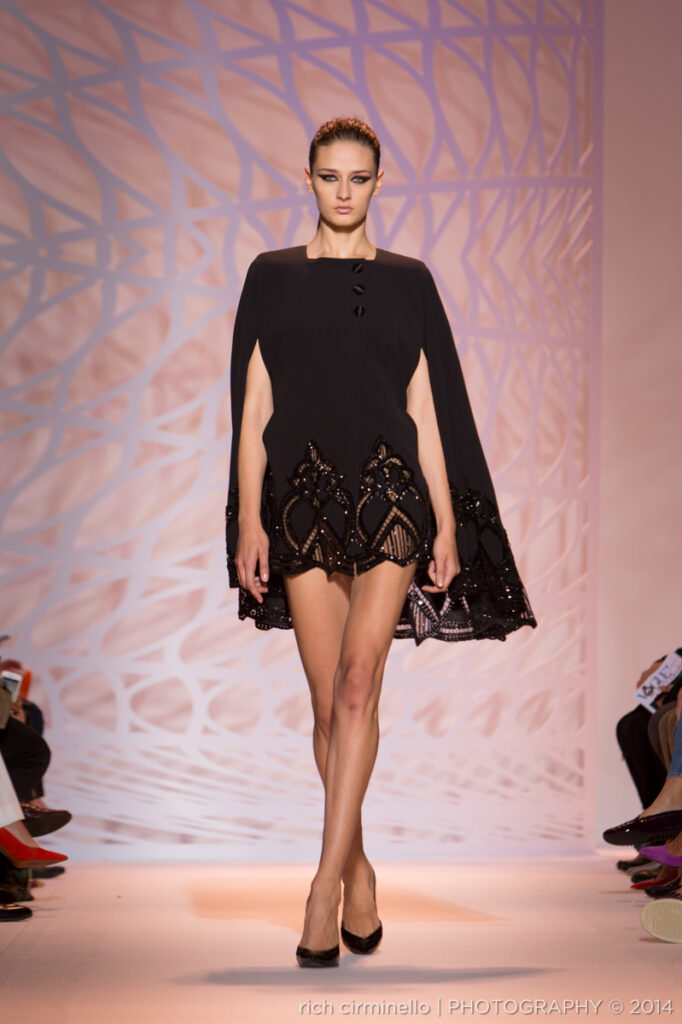 Model wearing a black cape dress by Zuhair Murad at Paris Haute Couture Fashion Week 2014, photographed by Rich Cirminello