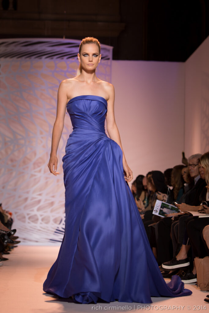 Model presenting a Zuhair Murad strapless satin gown at Paris Haute Couture Fashion Week 2014, captured by Rich Cirminello.