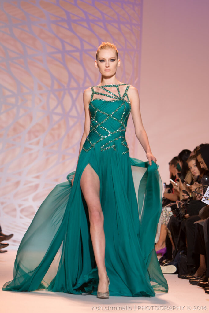 Zuhair Murad model in a structured teal gown walking the runway at Paris Haute Couture Fashion Week 2014. Photography by Rich Cirminello.