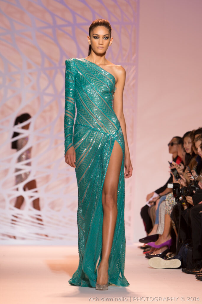 Model in a teal Zuhair Murad gown walking the runway at Paris Haute Couture Fashion Week 2014. Photographed by Rich Cirminello