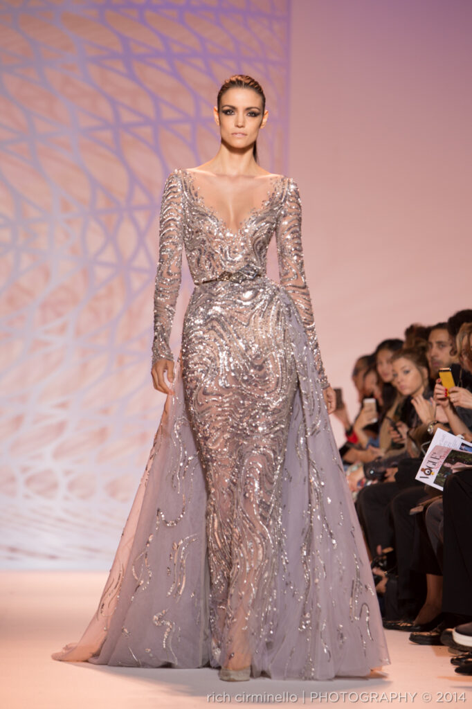 Model in an embellished silver gown walking the runway at Zuhair Murad's 2014 Paris Haute Couture Fashion Week show, photographed by Rich Cirminello.