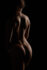 Fine-art bodyscape: a woman's back sculpted by low light, Dallas