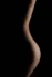 Curve of the waist and hip in side light, fine art bodyscape