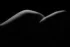 Black and white bodyscape of a hip curve lit like a landscape