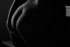 Black and white bodyscape of the back and hips in shadow