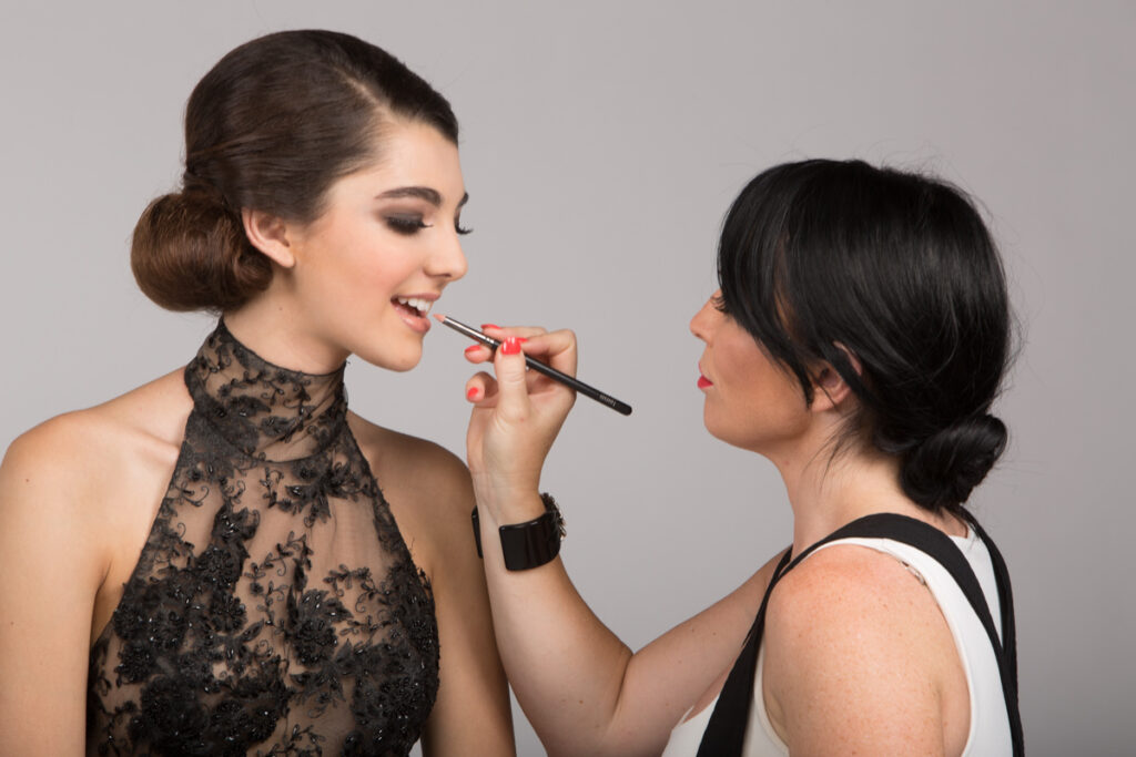 Professional makeup artist at work before a portrait session